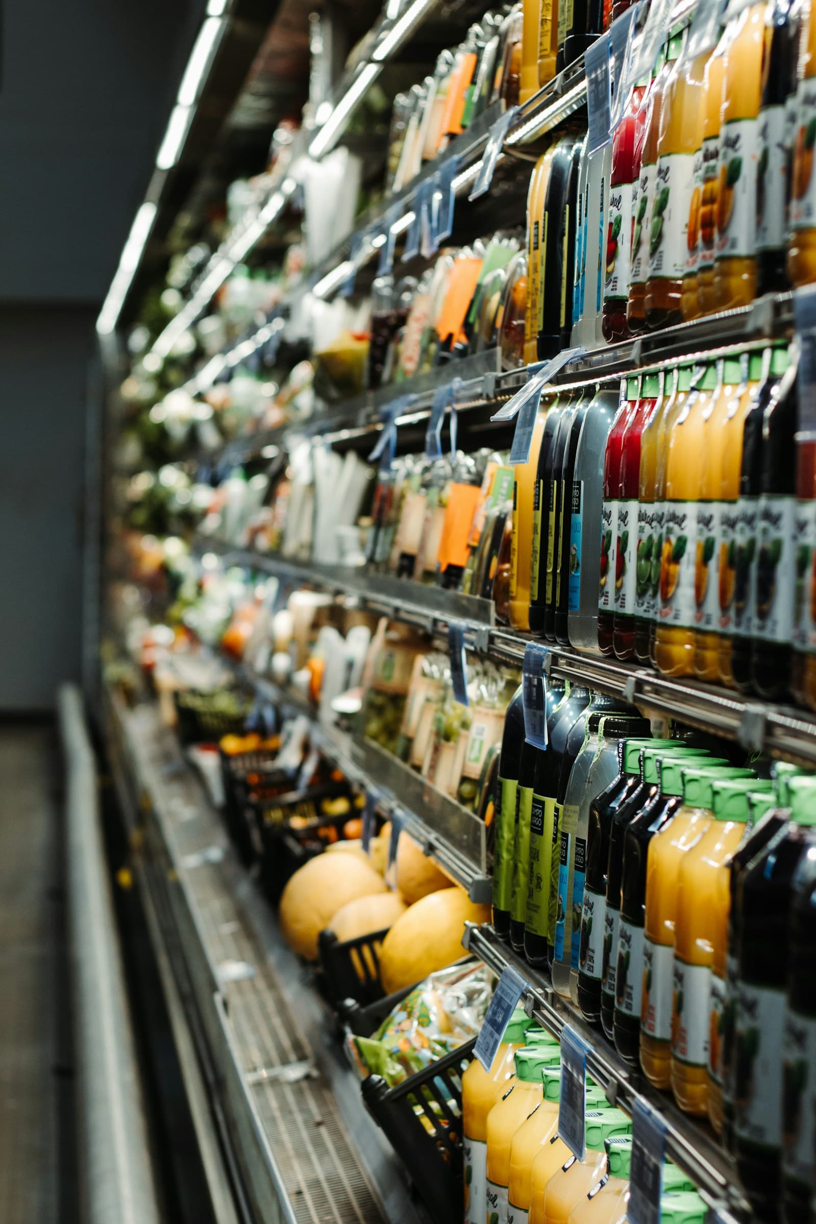 Refrigerated juice and produce shelves in a supermarket