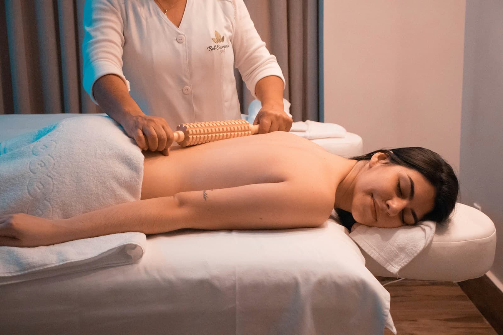 Spa therapist performing a back massage treatment