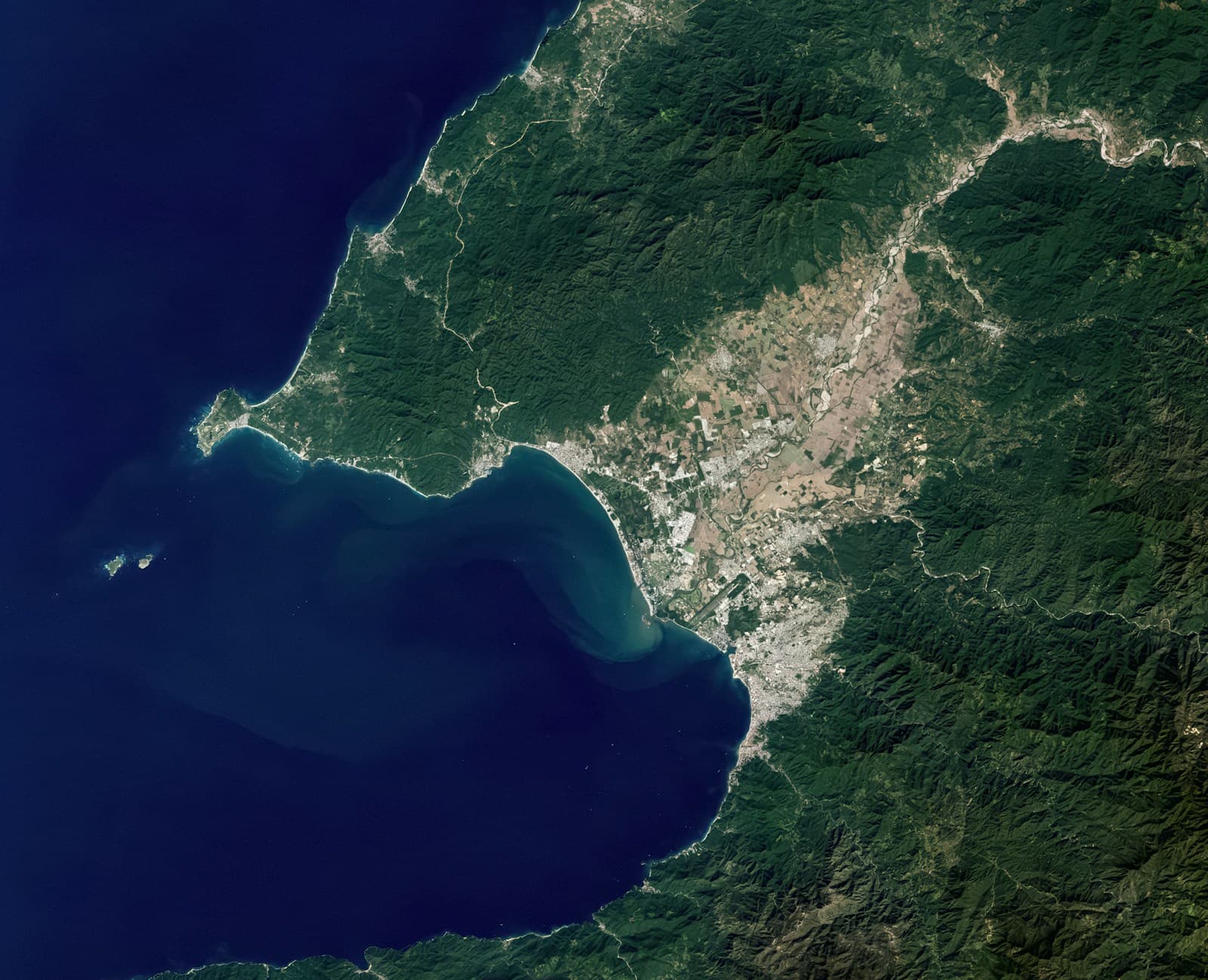 Satellite view of coastal land, ocean, and regional development